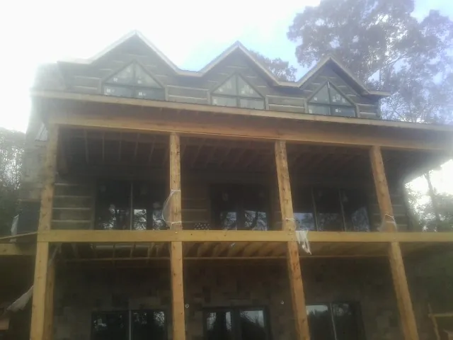 Dormers and porch framing on a large log home under construction in Oakdale